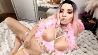 A pink-clad beauty indulges with a silicone toy