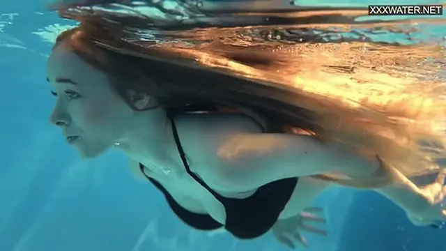 Blonde teen sizzles in naked pool fun