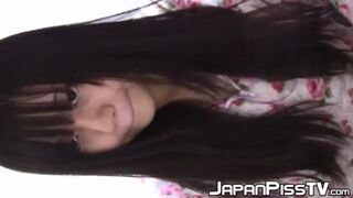 Japanese seductress toys with her feline while drinking from cups