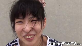 Tiny Japanese淫荡girl pissing while fondling her 潿 outdoors