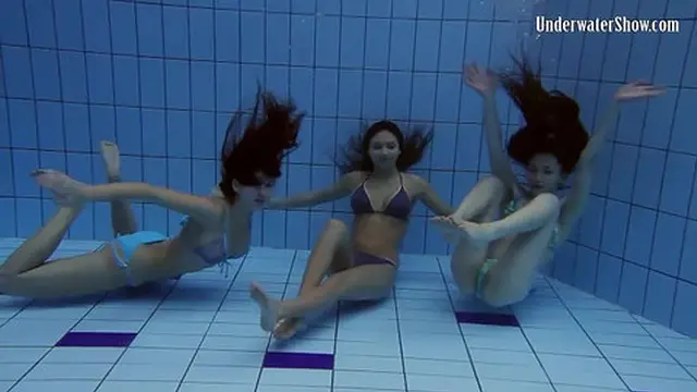 Hot girls playfully explore the pool with wild intimacy